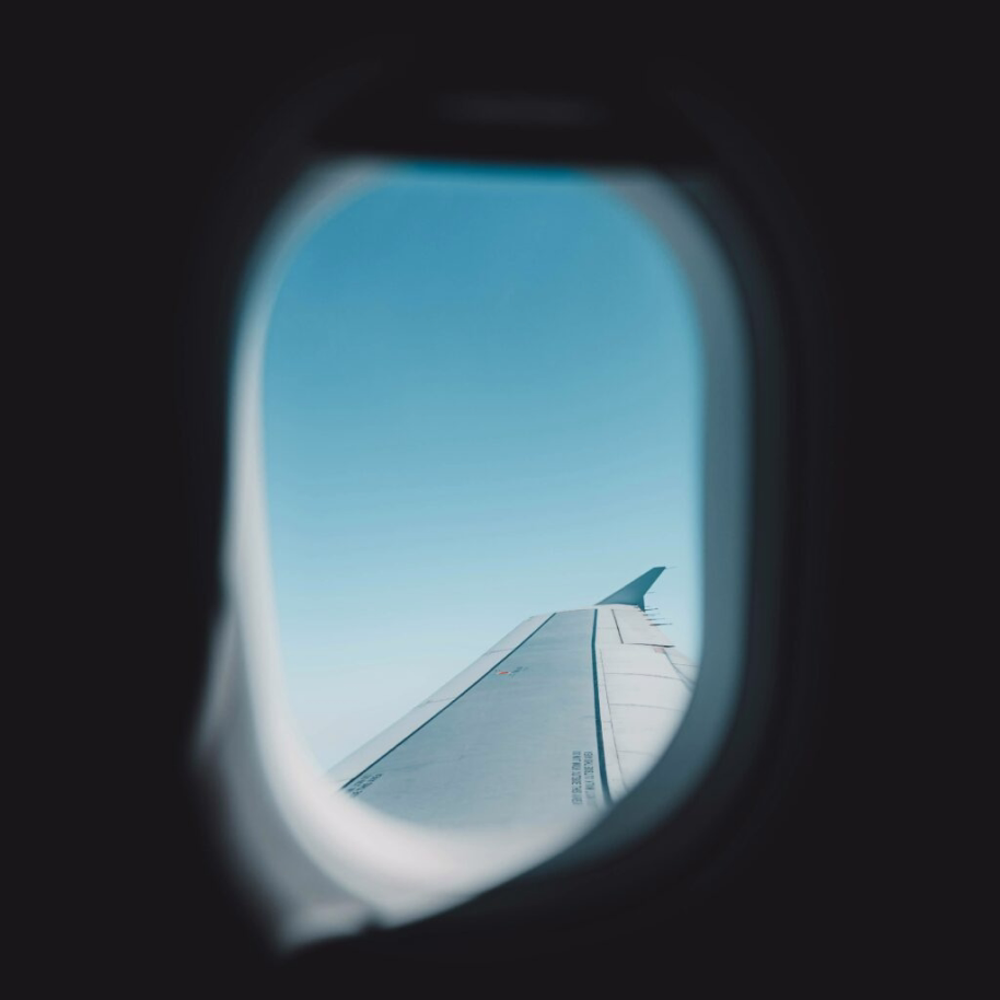 Image from inside a plane window, looking out on plane wing, for a blog on global branding strategies