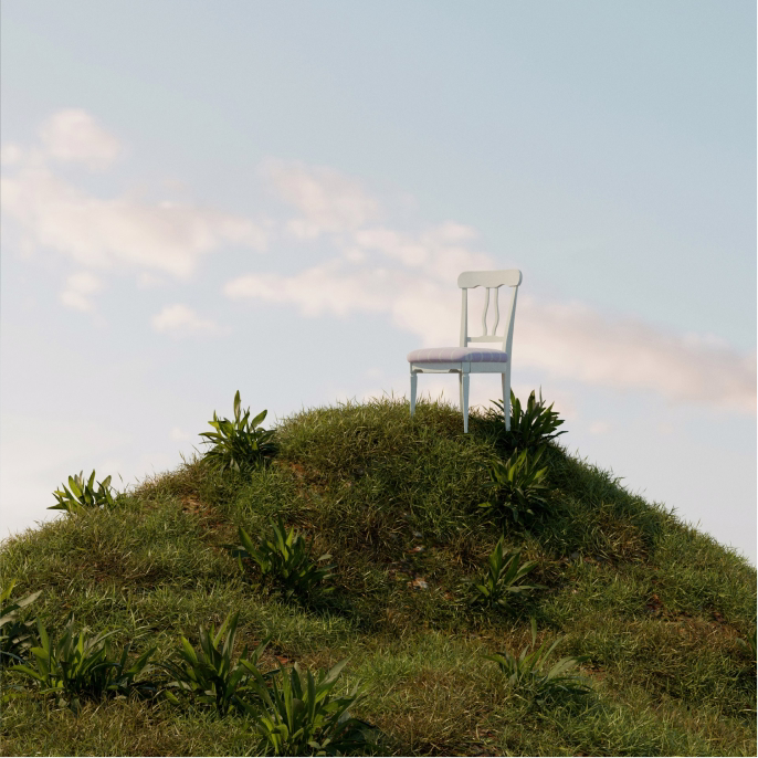 Image of a chair on the top of a grassy hill.