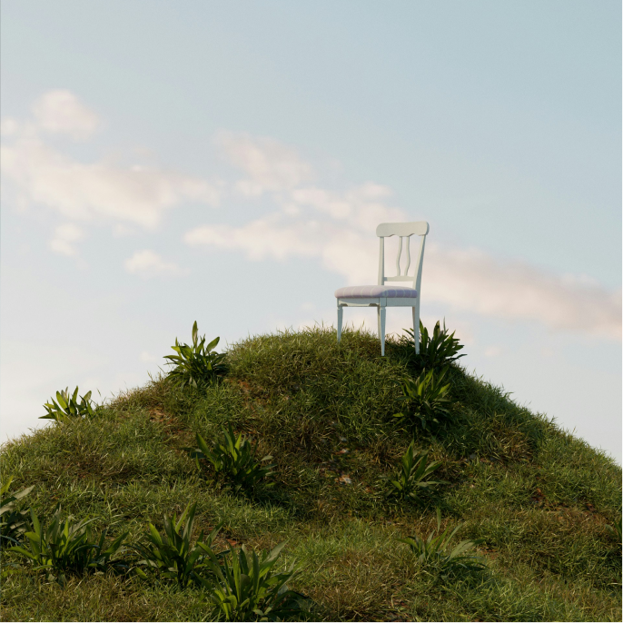 Image of a chair on the top of a grassy hill.